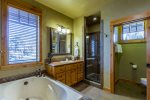 Master bathroom with full size soaking tub and walk in shower. 